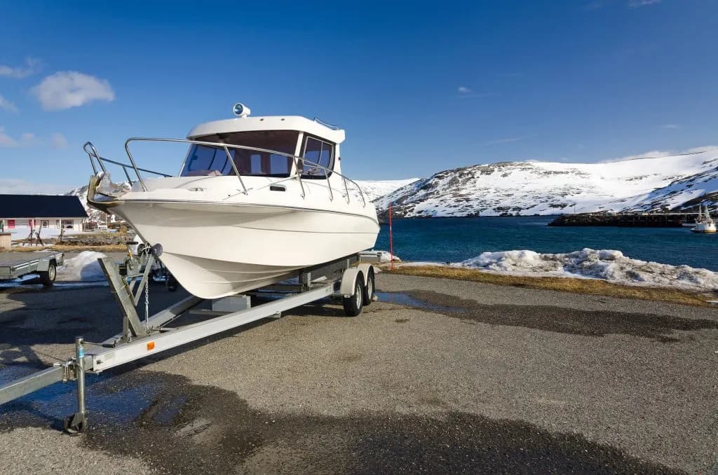Boat on trailer being transported through Canadian mountains